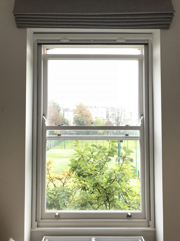 Retractable insect screen on sash window